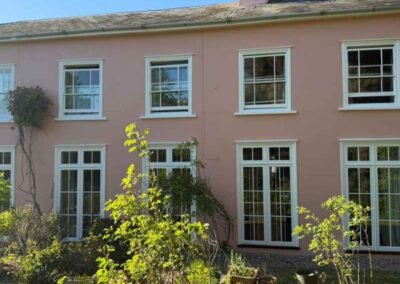 Pink house with white windows on the exterior
